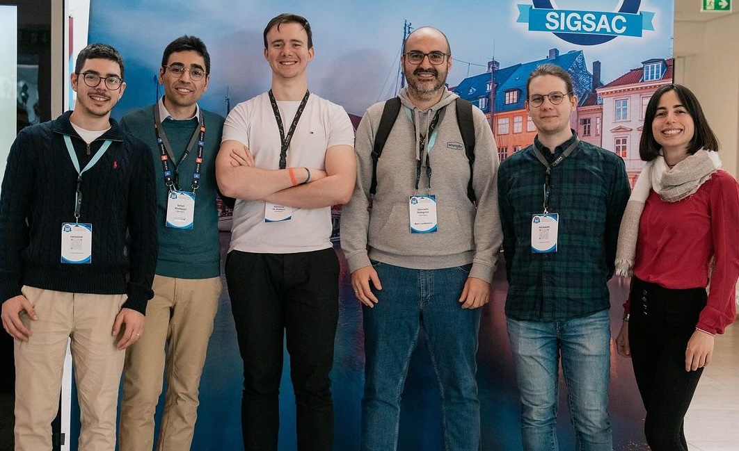 Group photo with the AppSec team in the hallway at ACM 2023 Conference on Computer and Communication Security.